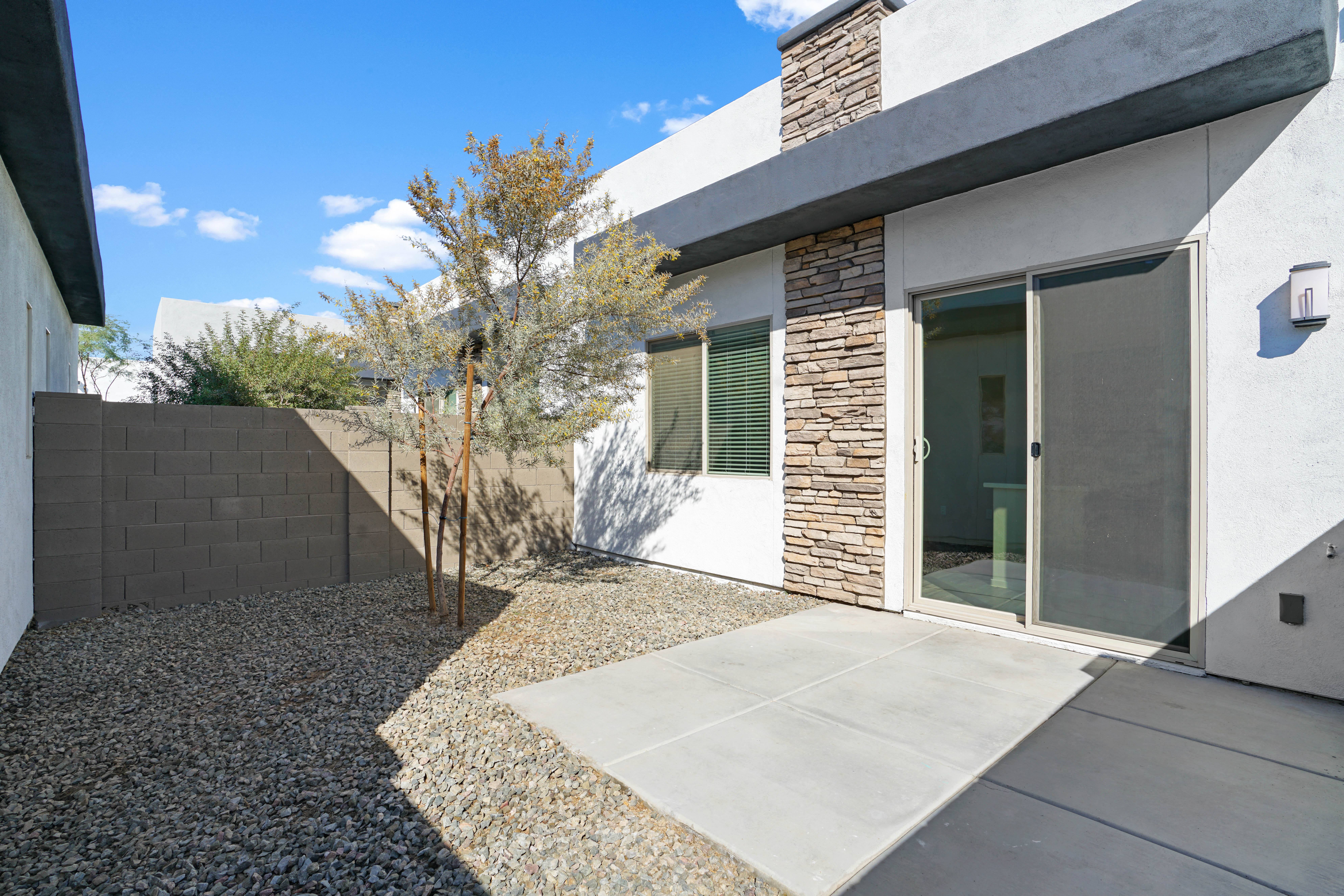 a view of the front of a house with a sidewalk and a tree at Olive Queen Creek Apartments, Arizona